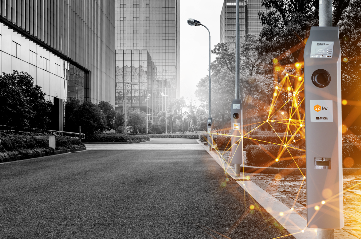  A street with buildings and a charging station on a street lamp